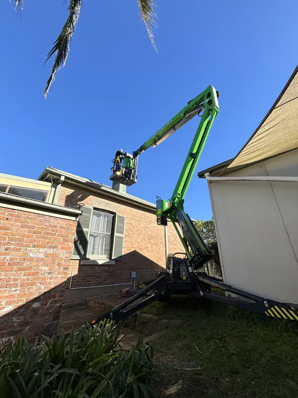 Apex Aerial Services — EWP accessing heritage brick house roofline